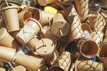 Eco-friendly disposable brown paper cups and plastic glasses used from coffee cafe, restaurants,...