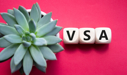VSA - Volume Spread Analysis symbol. Wooden cubes with word VSA. Beautiful red background with...