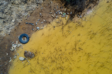 Drone aerial of lake polluted with waste garbage. Environmental pollution. Toxic water