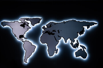 A world map on the wall, illuminated by neon lights