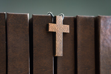 Necklace with wooden cross on books, Christian concept, religious symbol