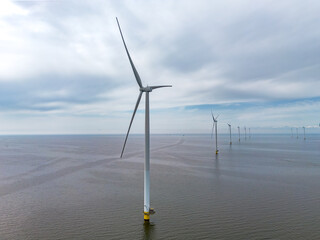 Aerial drone image of wind farm of wind mills, generators, wind turbines, off shore in a sea or...