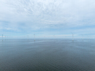 Aerial drone image of wind farm of wind mills, generators, wind turbines, off shore in a sea or...