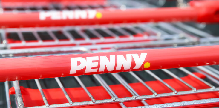 Viersen, Germany - May 1. 2024: Logo lettering of german discounter Penny on shopping carts handle in row