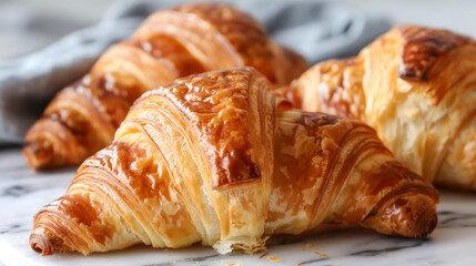 Croissants are flaky, buttery pastries from France. They have a unique crescent shape and are golden brown. They're perfect for breakfast because they are both crispy and soft.