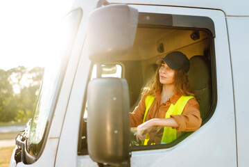 Truck driver woman, trucker occupation in Europe for females. People and industrial transportation concept.