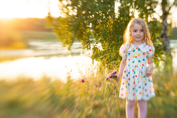 girl at sunset after the rain, summer rain, summer, sunset, girl in a dress with a heart, hearts, blonde, childhood, child smiling, laughter