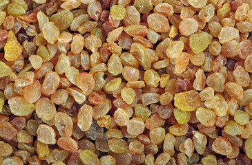 golden raisin texture background. dried grapes. top view