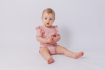 Cute baby girl in pink bodysuit on white background, space for text