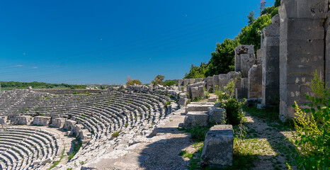 Naklejka premium Picturesque ruins of an amphitheater in the ancient city of Perge, Turkey. Perge open-air museum.