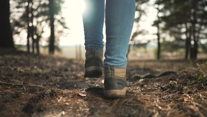 tread forward walk through forest terrain. Walking shoes forest path nature embrace. Close up shoes walk among trees. Shoes journeying walk woods. Walking shoes crunch leaves peaceful forest stroll.