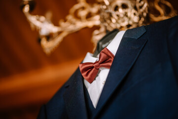Valmiera, Latvia - August 19, 2023 - Close-up of a man's suit jacket with a red bow tie and white...