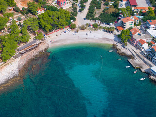 AERIAL: Flying over small picturesque bay of a remote coastal village in Hvar