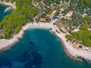AERIAL: A breathtaking shot of a small rocky bay near a secluded Hvar settlement