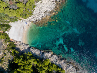 TOP DOWN: Flying high above a pebble beach and the turquoise Mediterranean sea.