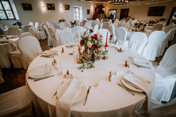 Valmiera, Latvia - August 19, 2023 - A wedding reception hall elegantly set with round tables...