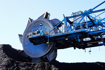 Cantilever bucket-wheel stacker reclaimer for handling of coal and ore storage yards.
