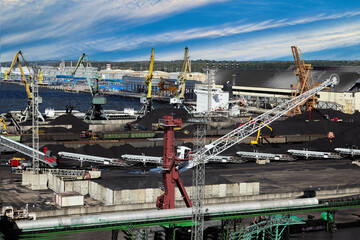 Sea trade port with coal terminal and liquid cargo complex behind.