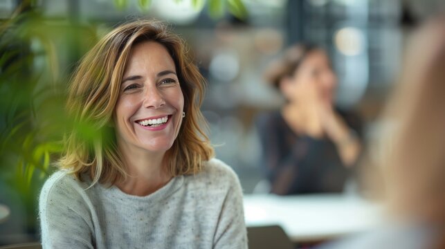 smiling Middle aged professional business woman executive HR manager having job interview or business discussion in corporate office meeting 
