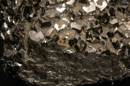 Ironed silver gemstone textured background. Texture of a large iced shaped iron mineral. Shining grey metallic crystal stone close up photo. 