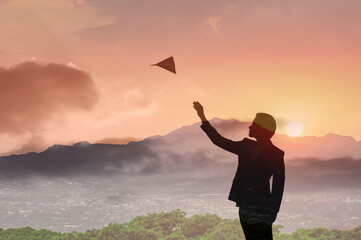 Man throwing airplane in the sky, vision, target, ambition, future goal concept 