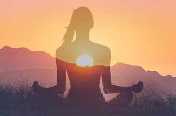 Fototapeta premium Woman in yoga pose, zen meditation at sunset. 