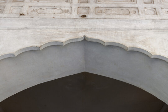 detail of a building An arch from Shalimar Garden Lahore white marble stone cusped arch garden built by emperor Shah Jahan in 1642. 