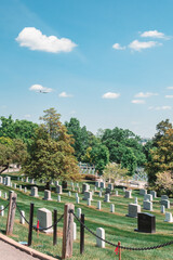 plane flies over arlington national cemetery