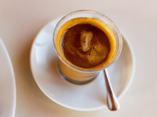 Cup of fresh cortado, Spanish beverage made of espresso and equal amount of steamed milk.