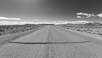 Black and white image of a lonely road in nevada 