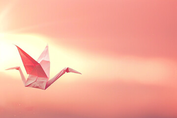 Naklejka premium A pink paper crane floating in the air against a pink sky.