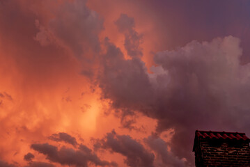 Beautiful orange sky with clouds, barbecue in the corner of the image