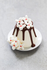 Cottage cheese Easter with chocolate. Decorated with white marshmallow flowers. Close-up