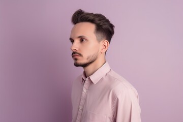 Fototapeta premium A man with a beard and short hair is wearing a pink shirt