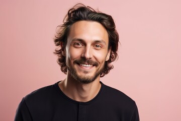 Fototapeta premium A man with a beard and a smile is wearing a black shirt