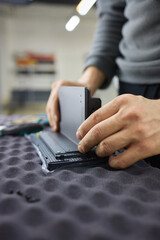 Hand holding metal on table Automotive design gadget