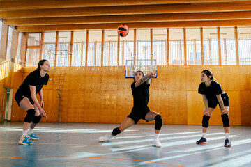 Portrait of a diverse young female volleyball players bumping a ball