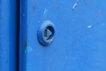 Close-up of Rusty Bolt on Blue Metal Surface