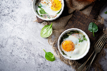 Baked spinach bacon eggs on a background