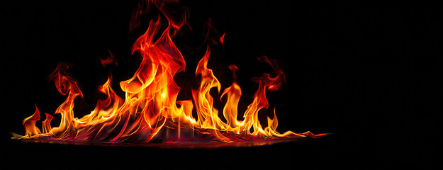 Vivid flames dance against a dark background, creating a dynamic and intense display of fire's natural beauty. The lively blaze captivates and mesmerizes, symbolizing both destruction and renewal.