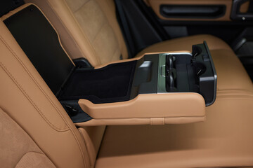 Luxury car back seat with open arm rest in sleek hardwood design