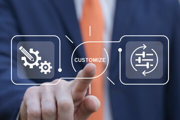 Business man using virtual touch screen presses word: CUSTOMIZE. Concept of customize business...
