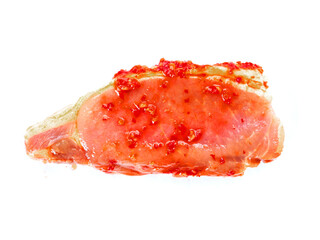 Pork chops in red Asian style marinade with chilly pepper on white background. Fine pork meat for...
