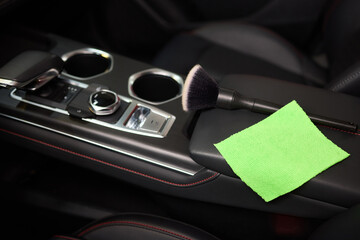 Vehicle dashboard includes a green cloth and a brush