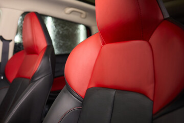 Red and black seats in the back of the car, part of the automotive design