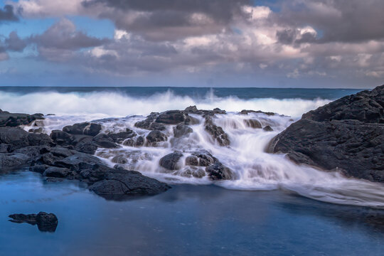 Ocean Waves Crashing Against Rocky Shore