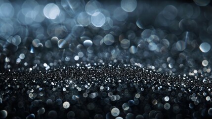 Shimmering silver sparkles on a dark background create a mesmerizing texture.