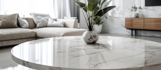 Table with a white marble top placed in front of a bright living room background for showcasing.