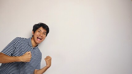 young asian man shows an enthusiastic pose