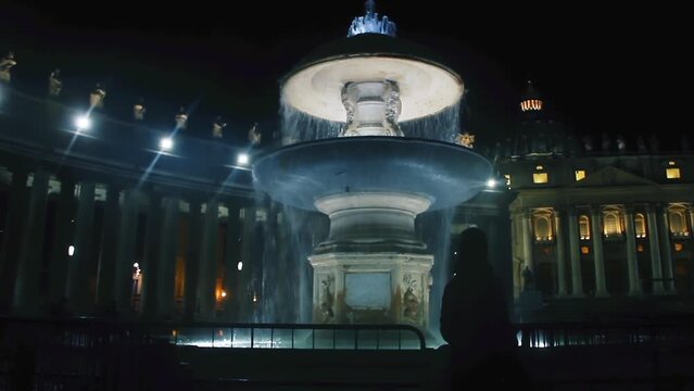 A Fountain in Front of St Peters Basilica and the Sistine Chapel at Night, Rome, Italy.
